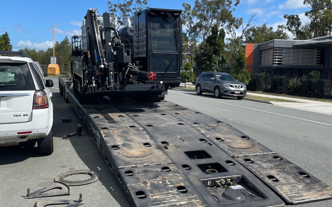 A tracked drill rig being unloaded,  it came from Sydney to Brisbane.